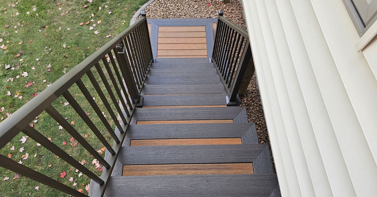 newly built deck with black railings - Barefoot Construction composite decking
