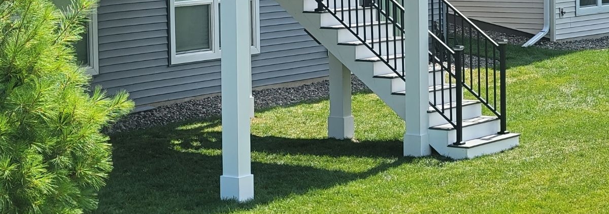 close up of white deck columns and footings - Barefoot Construction deck construction