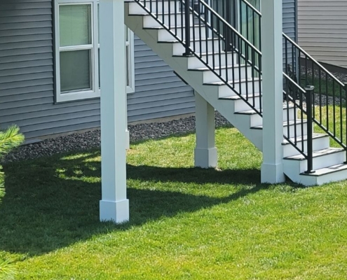 close up of white deck columns and footings - Barefoot Construction deck construction