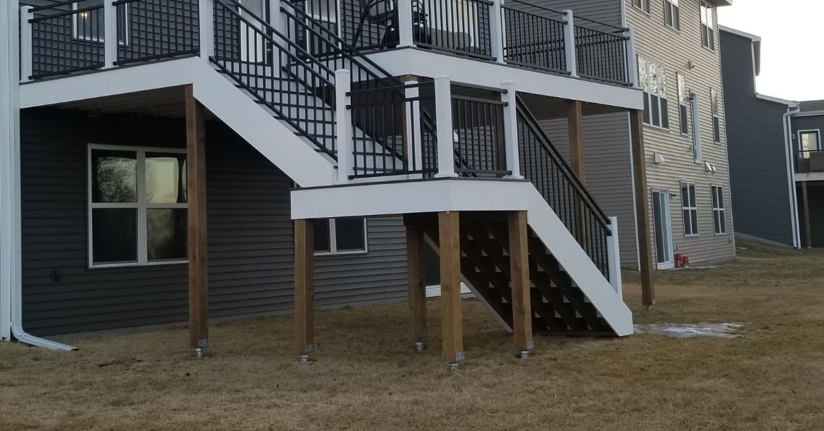 close up of white deck columns and wood footings - Barefoot Construction deck construction