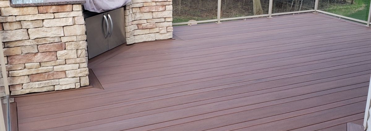 composite deck with a stone barbeque - Barefoot Construction composite decking