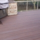 composite deck with a stone barbeque - Barefoot Construction composite decking