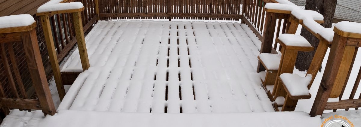 wood deck covered in snow - Barefoot Construction deck frost heave repair MN