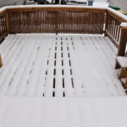 wood deck covered in snow - Barefoot Construction deck winterization