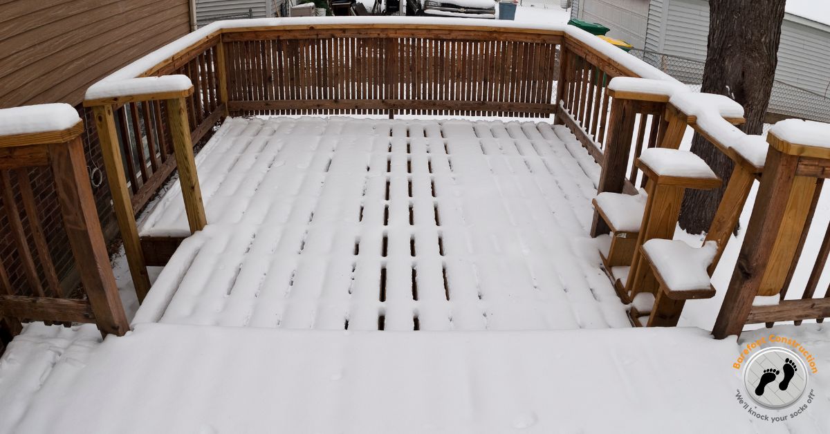 wood deck covered in snow - Barefoot Construction deck frost heave repair MN