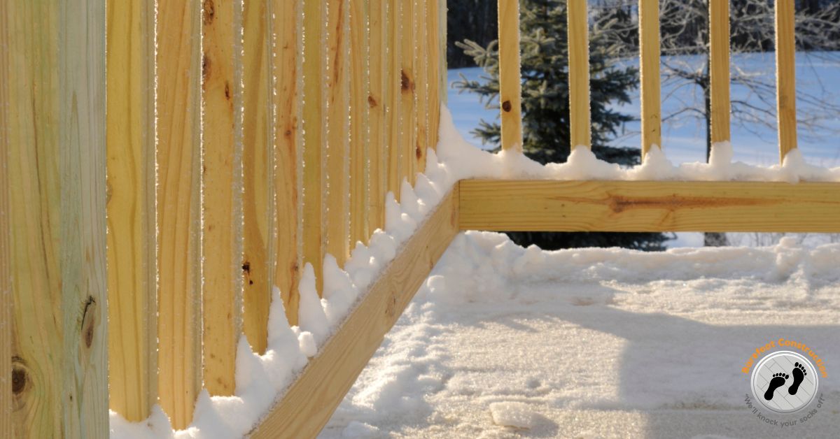 wood deck covered in snow - Barefoot Construction building a deck