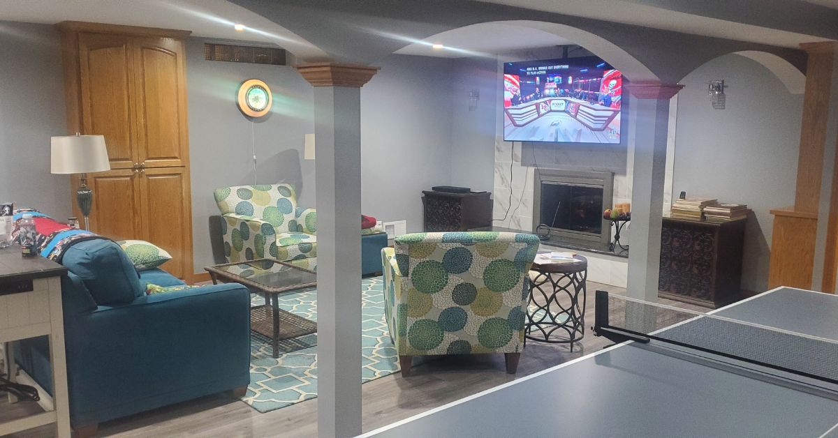 finished basement with grey walls and light wood trim - Barefoot Construction basement finishing