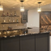 finished basement with a wet bar area - Barefoot Construction basement finishing