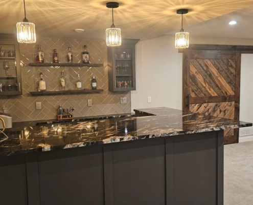 finished basement with a wet bar area - Barefoot Construction basement finishing