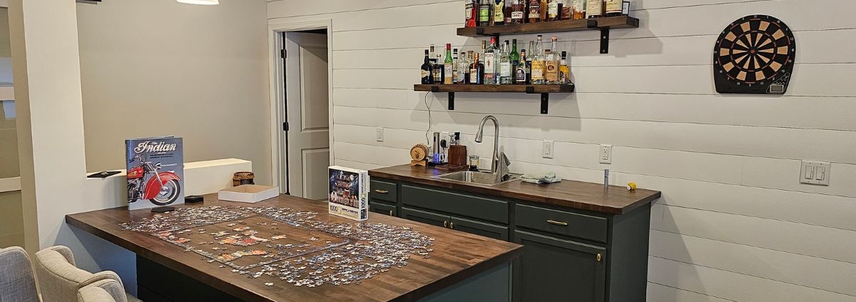 finished basement with a wet bar - Barefoot Construction basement remodeling