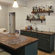 finished basement with a wet bar - Barefoot Construction basement remodeling