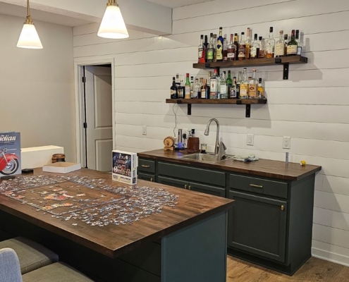 finished basement with a wet bar - Barefoot Construction basement remodeling