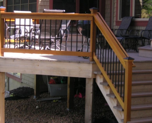 new deck with wood and black railings - Barefoot Construction decking materials