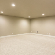 empty living space in a basement - Barefoot Construction basement finishing