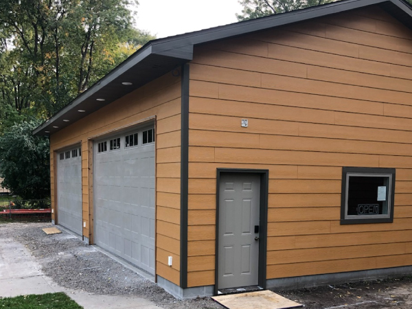 detatched garage with a white door - Barefoot Construction Deck Construction, Basement Finishings and Home Additions
