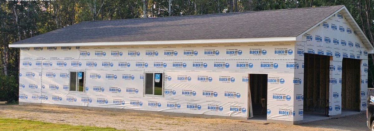 home addition with plastic wrap and a grey roof - Barefoot Construction home addition