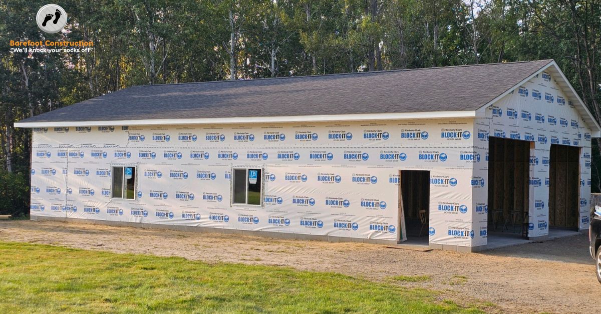 home addition with plastic wrap and a grey roof - Barefoot Construction home addition
