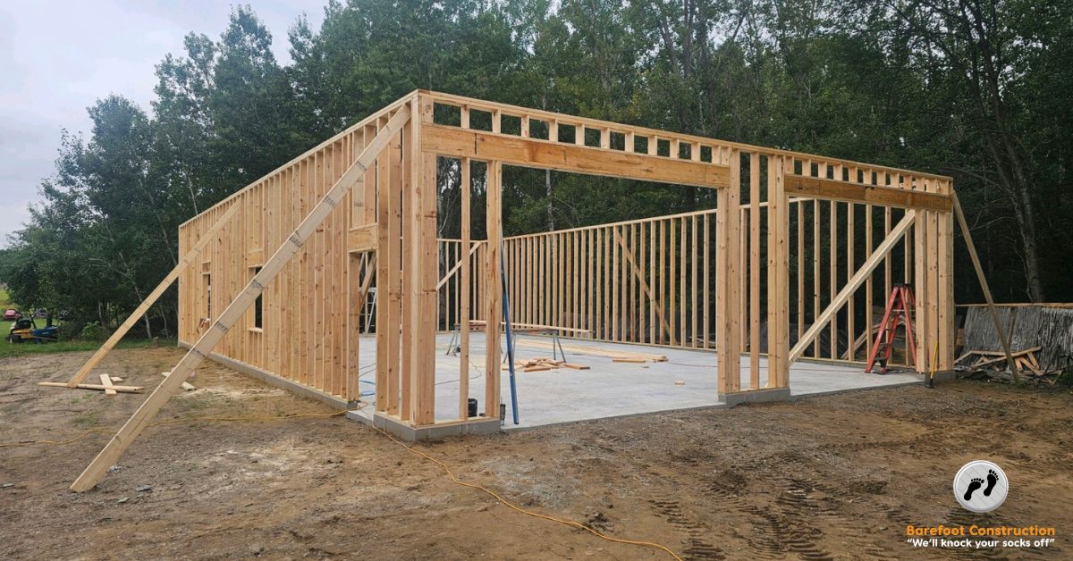 unfinished home addition with wood studs and a concrete slab - Barefoot Construction home addition