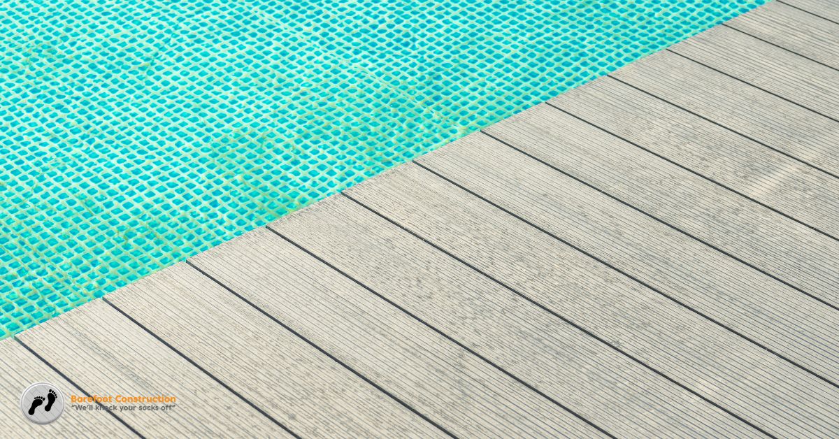 blue pool surrounded by deck boards and chairs - Barefoot Construction composite decking