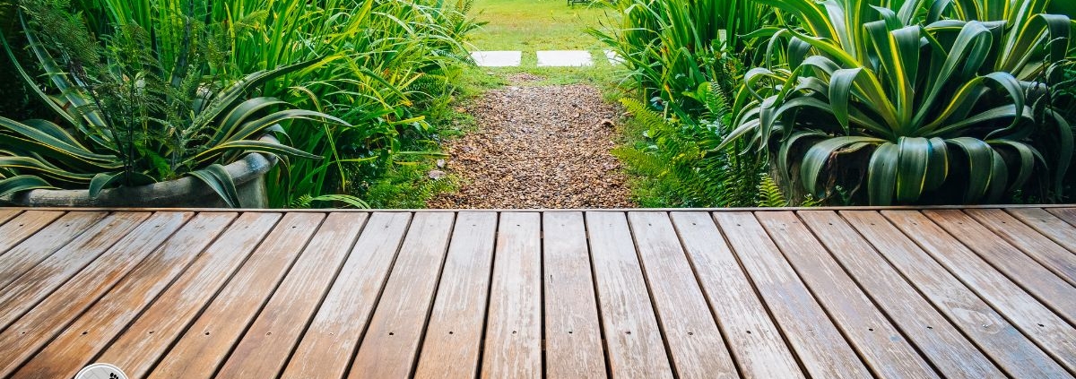wood deck with view of large green plants - Barefoot Construction deck construction