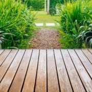 wood deck with view of large green plants - Barefoot Construction deck construction