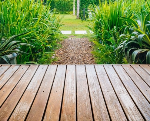 wood deck with view of large green plants - Barefoot Construction deck construction