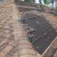 close up of a damaged roof with missing shingles - Barefoot Construction roof replacement