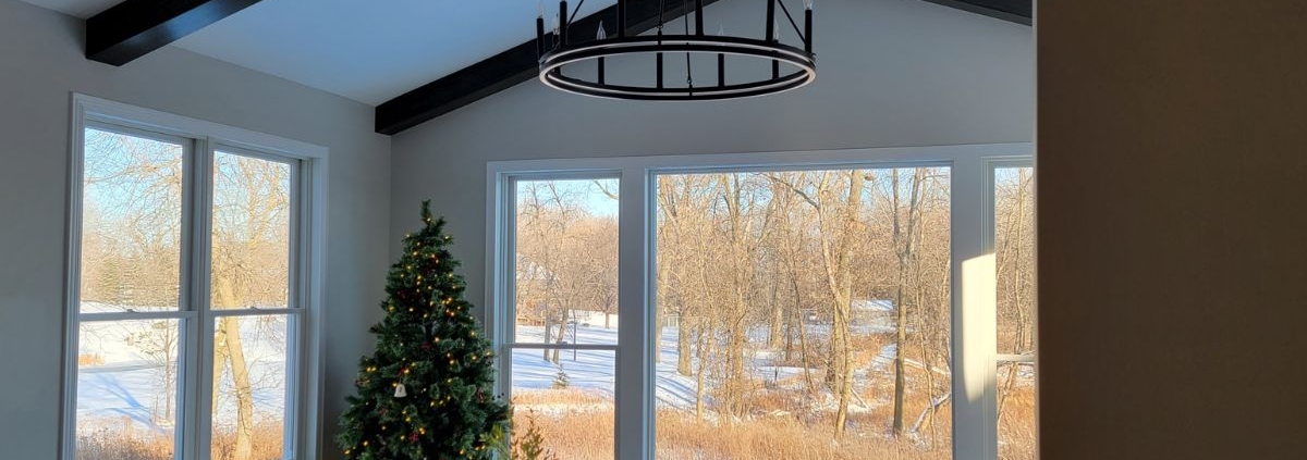 home addition with a large window and a chandelier - Barefoot Construction home addition