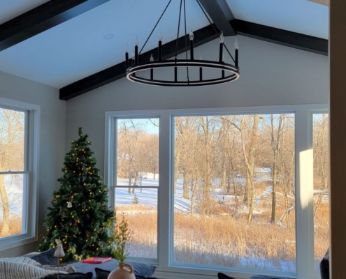 home addition with a large window and a chandelier - Barefoot Construction home addition