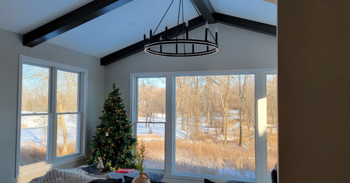 home addition with a large window and a chandelier - Barefoot Construction home addition