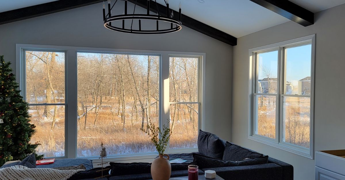 home addition with a large window and a chandelier - Barefoot Construction home addition