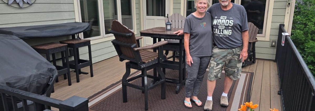 Mitch and Sandy posing on their new composite deck - Barefoot Construction