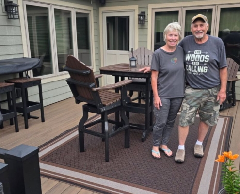 Mitch and Sandy posing on their new composite deck - Barefoot Construction