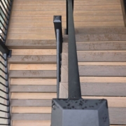 two tiered composite decking stairs with black rails - Barefoot Construction decking material cost comparison