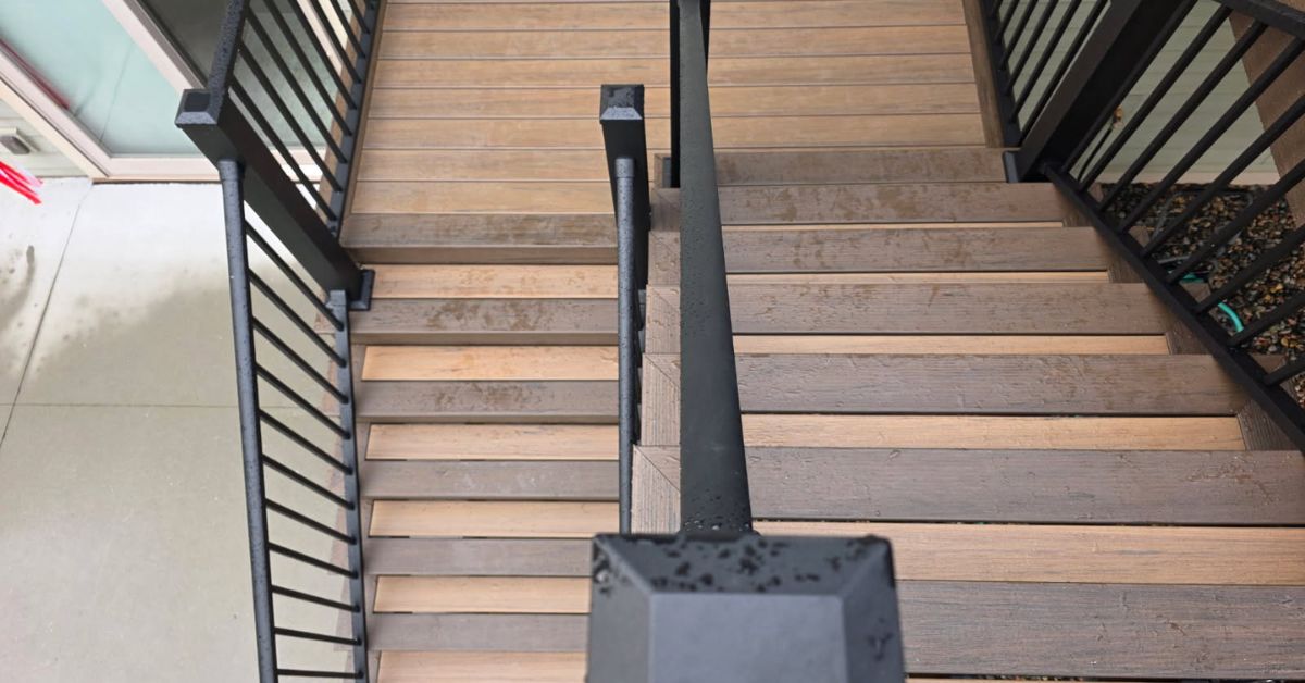 two tiered composite decking stairs with black rails - Barefoot Construction composite deck