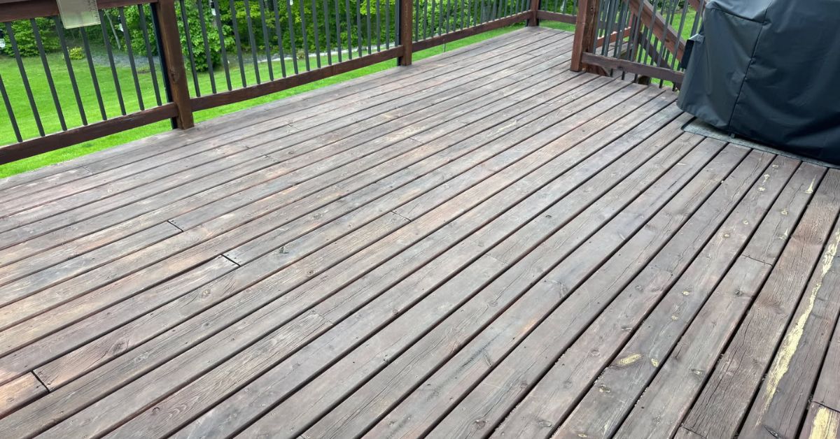 wood deck with peeling stain and warped railings - Barefoot Construction composite deck