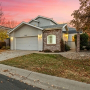 BarefootConstruction-basement-finishing-Minnesota-090520251 suburban home with bare trees and leaves on the grass - Barefoot Construction home remodeling