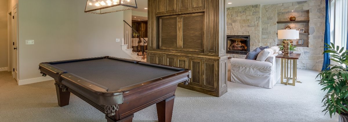 finished basement basement space with a dark wood pool table - Barefoot Construction basement finishing East Bethel