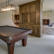 finished basement basement space with a dark wood pool table - Barefoot Construction basement finishing East Bethel