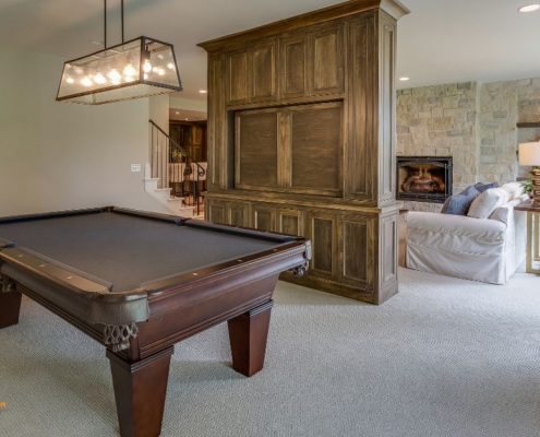 finished basement basement space with a dark wood pool table - Barefoot Construction basement finishing East Bethel