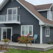 exterior of a home with grey siding and a composite deck - Barefoot Construction Basement Finishing ROI Maple Grove