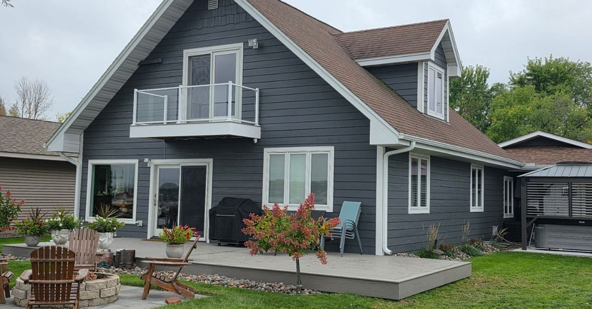 exterior of a home with grey siding and a composite deck - Barefoot Construction Basement Finishing ROI Maple Grove