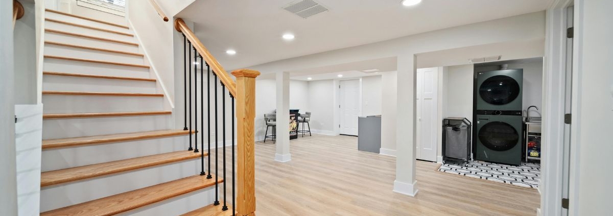 wood stairs going down to a finished basement - Barefoot Construction basement remodel