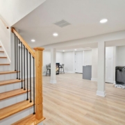wood stairs going down to a finished basement - Barefoot Construction basement remodel