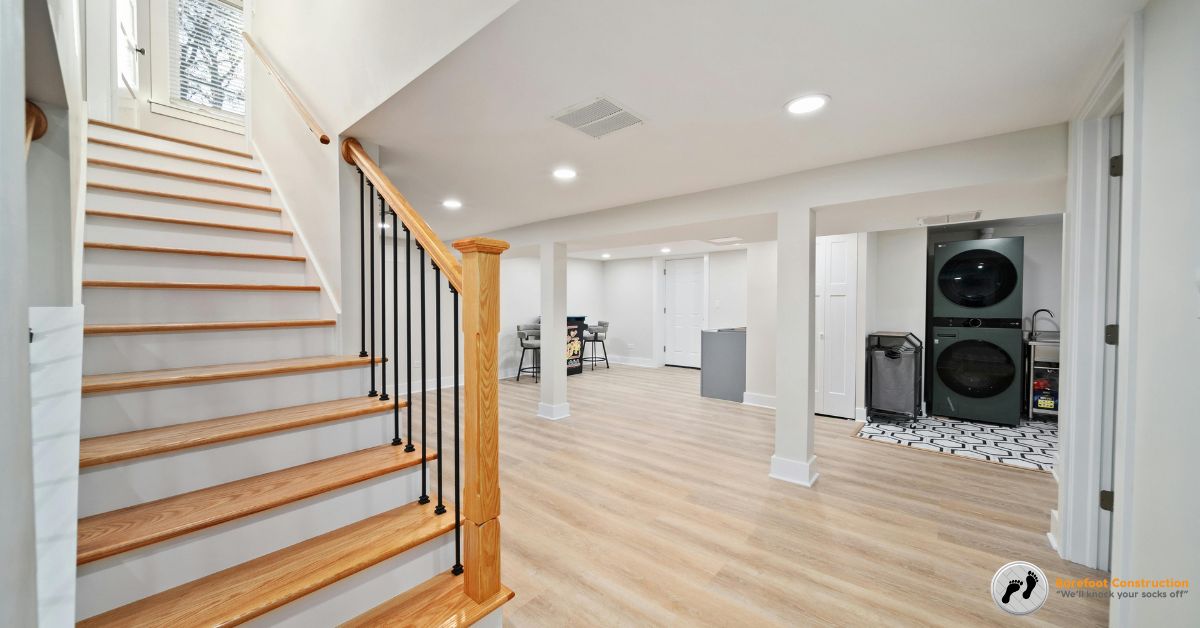 wood stairs going down to a finished basement - Barefoot Construction basement remodel