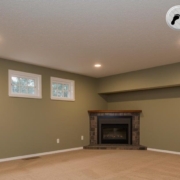 finished basement with sage green walls and beige carpet - Barefoot Construction Elk River basement remodel