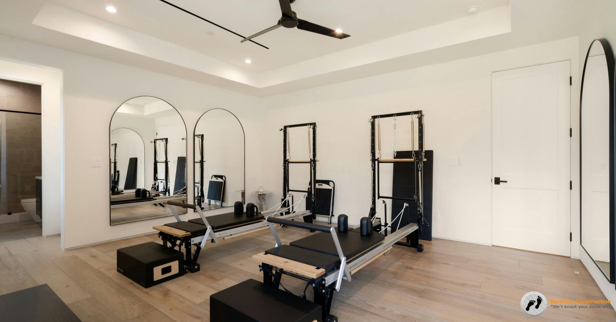 workout equipment in a finished basement - Barefoot Construction basement home gym