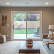 finished basement with a sliding glass door to the backyard - Barefoot Construction Basement Finishing ROI Maple Grove